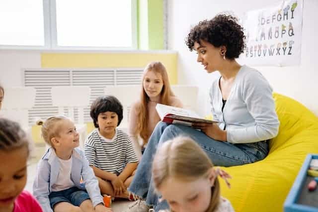 teacher reading book in classroom