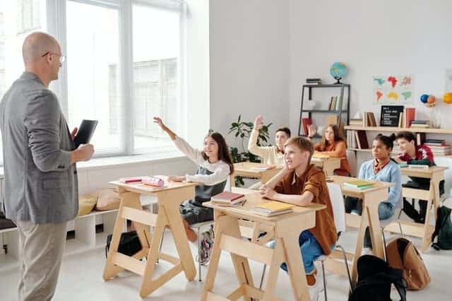 Class raising hands to answer a question