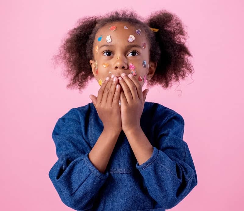 girl with stickers on face